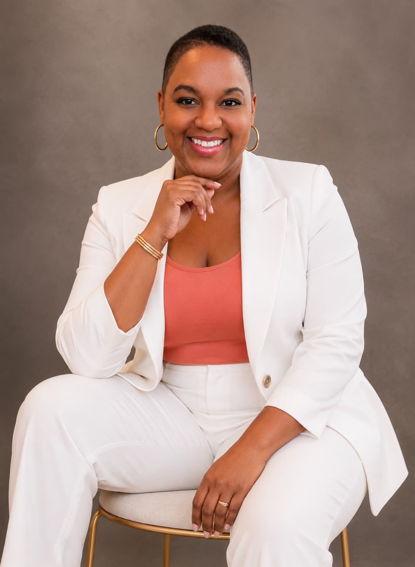 Professional portrait of Dr. Ayele Kumari in a white suit